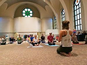 密歇根州立大学丹佛 staff and students do yoga in St. Cajetans.